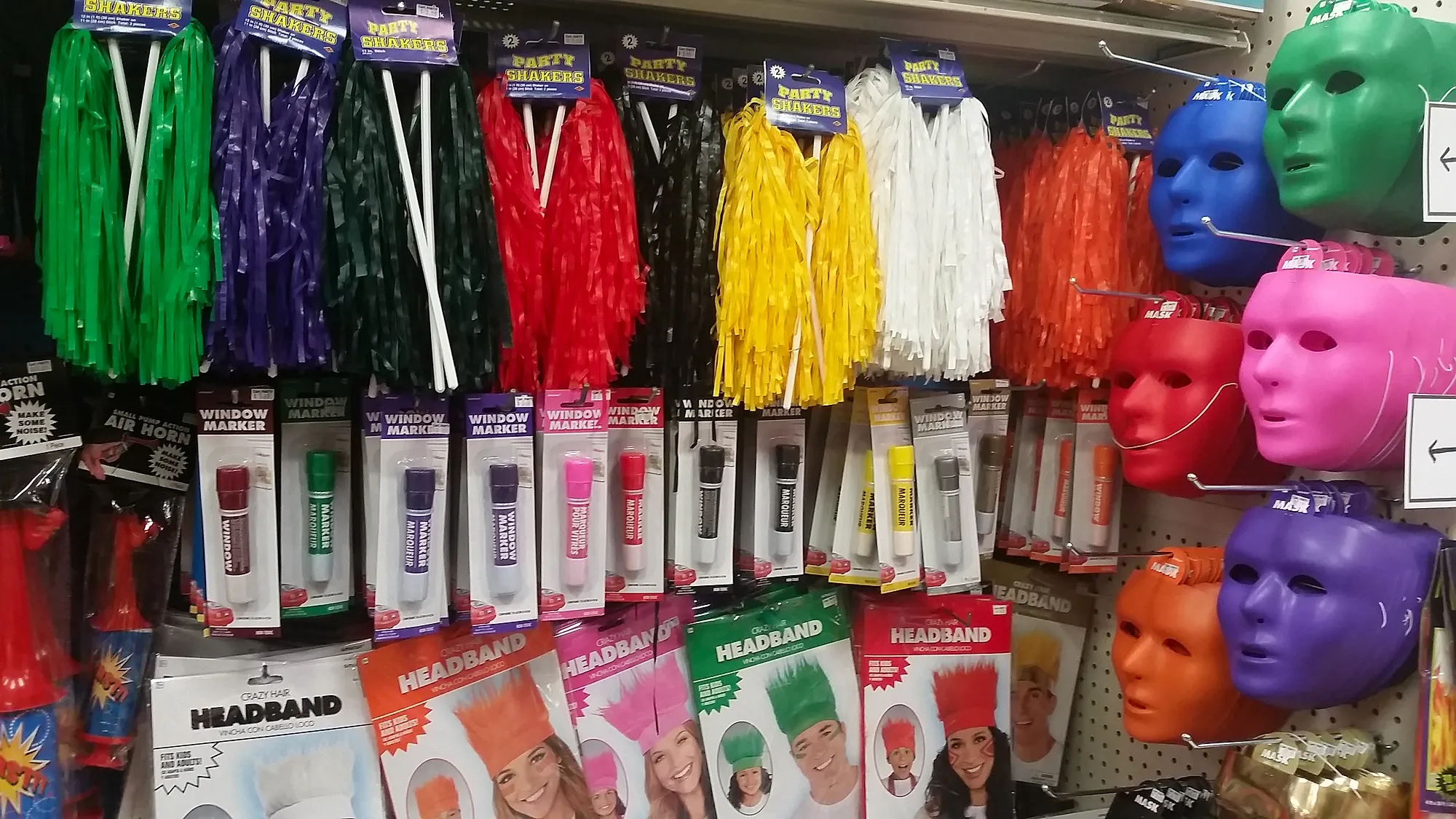 Pom-pom shakers, solid-color masks and novelty headbands on display