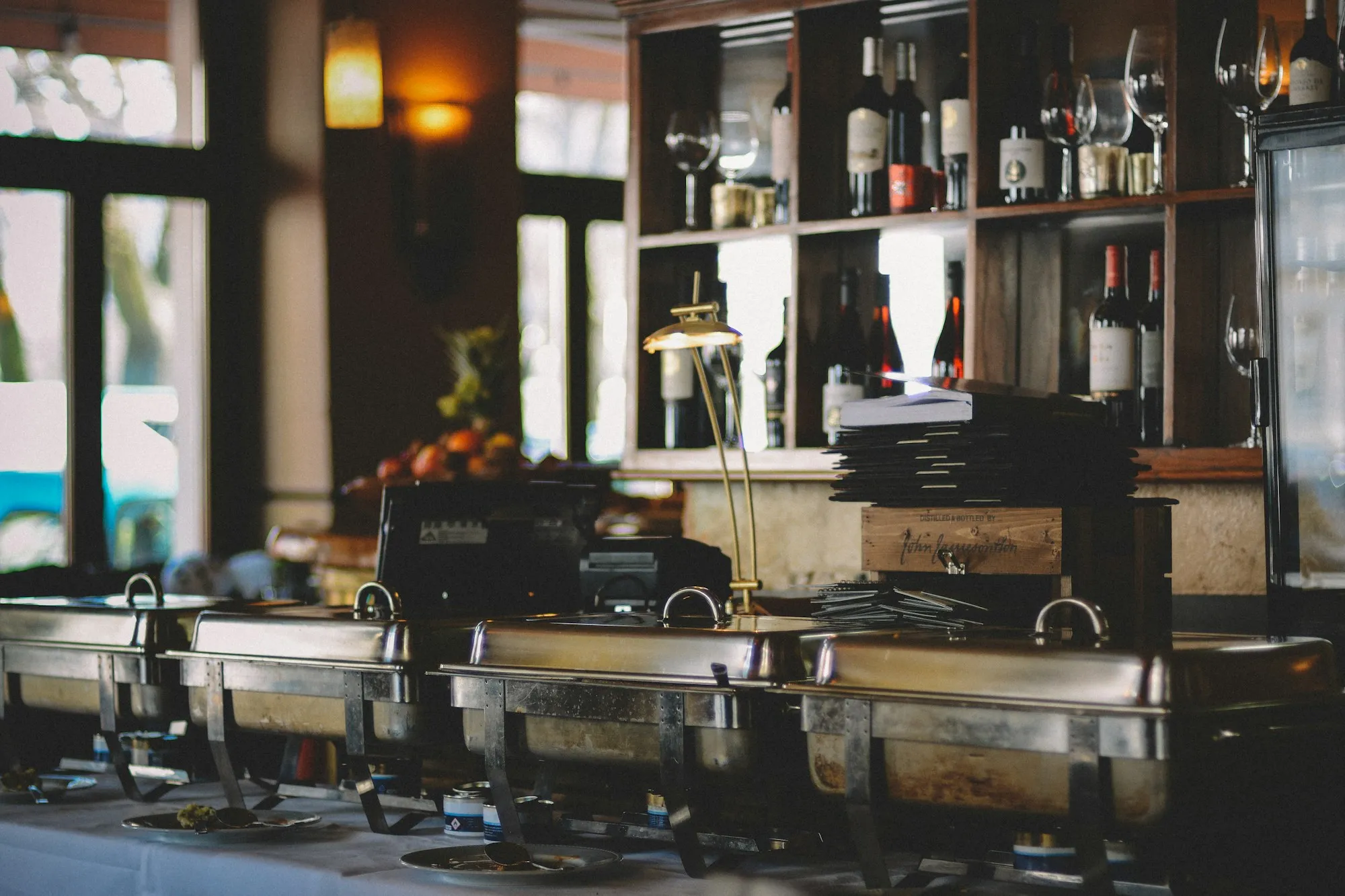 Row of stainless steel chafing dishes on a buffet line