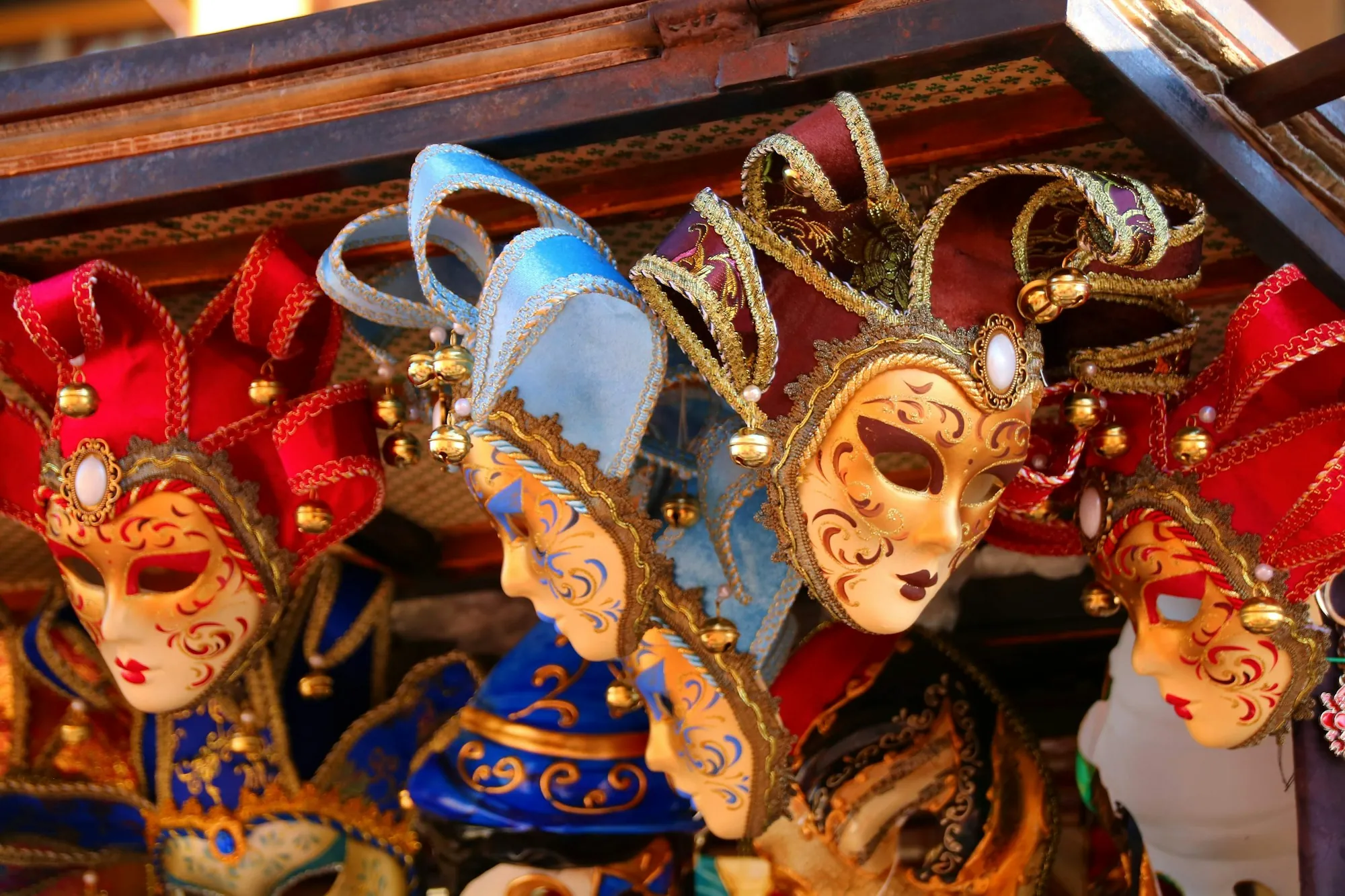 Red, gold and blue Venetian masquerade masks on display