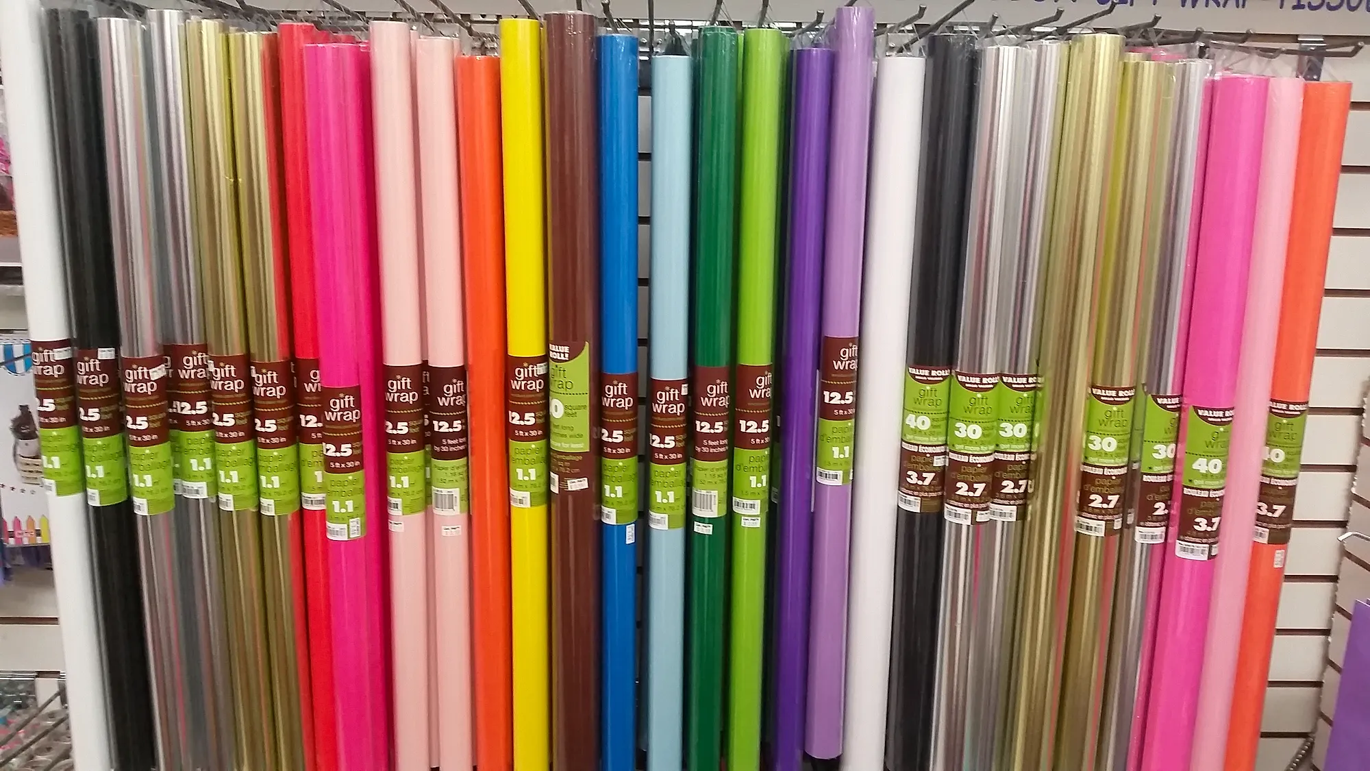 Rack of gift wrap and cellophane rolls at Capt. Party